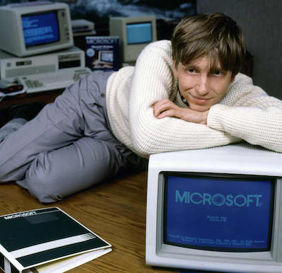 Bill Gates on a desk with a computer